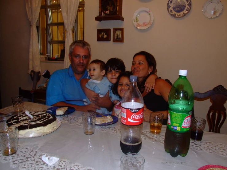 a family poses at the dinner table to take pictures