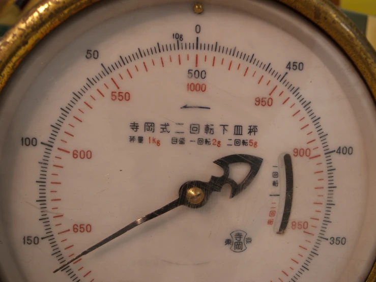a close up of a thermometer with writing on it