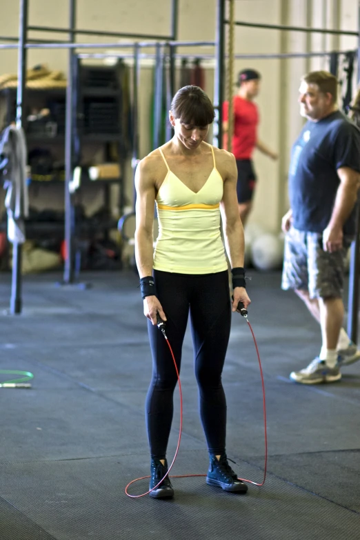 a woman in the gym with her exercise rope