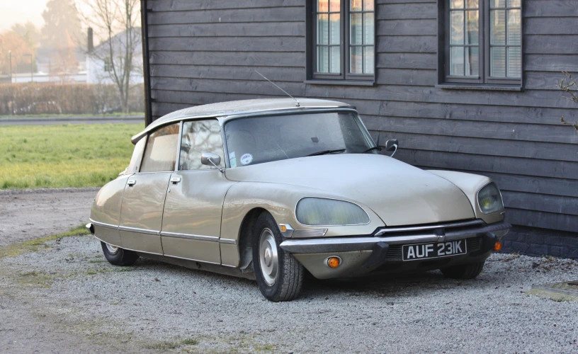 a car sitting in front of a wooden building