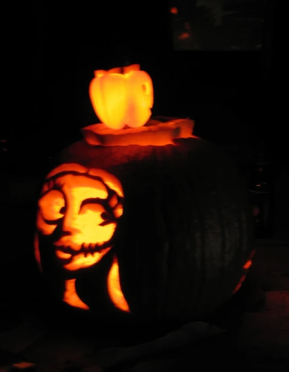 a pumpkin carved into a cat sitting inside of a pumpkin