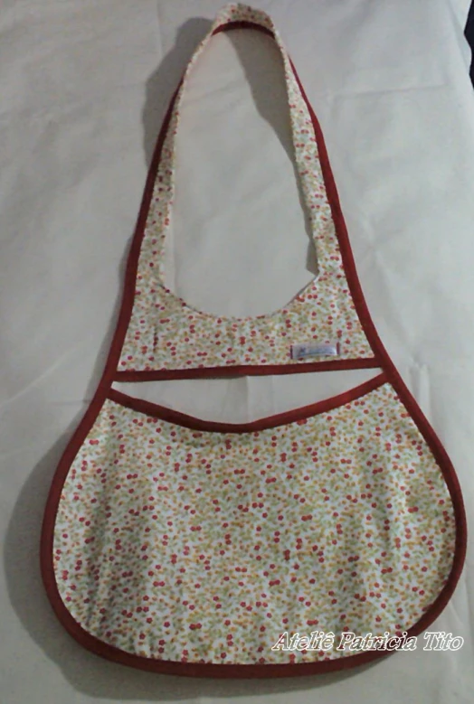 an apron has red trim on it with some white flowers