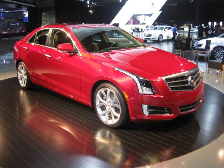 a red cadillac on display at an auto show