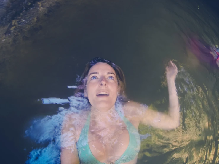 a woman in a bikini swimming in water