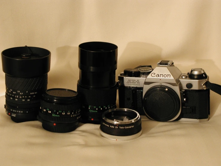 several different cameras sitting on a cloth