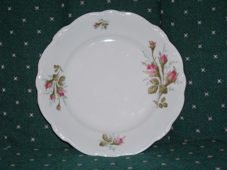 plate with pink flowers on green and white cloth