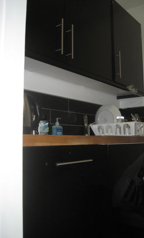 a kitchen sink under some cabinets on a counter