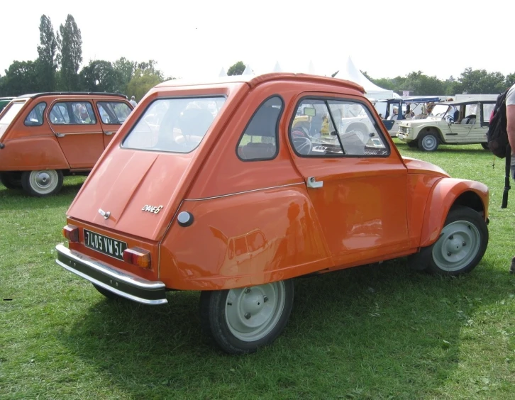 several small cars that are on some grass