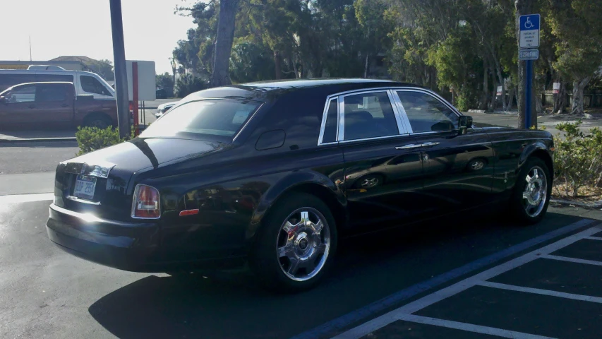 a large black car parked in a parking lot