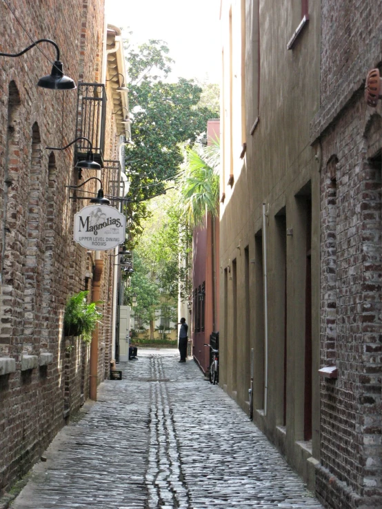 two people walk down an old narrow street