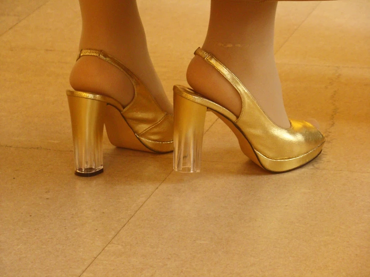 gold shoes and golden pant legs with heels