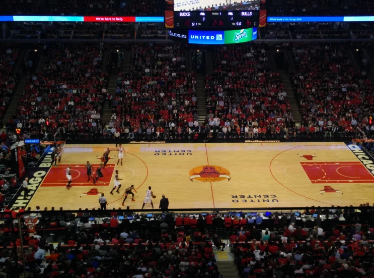 a basketball court with people in it during a game