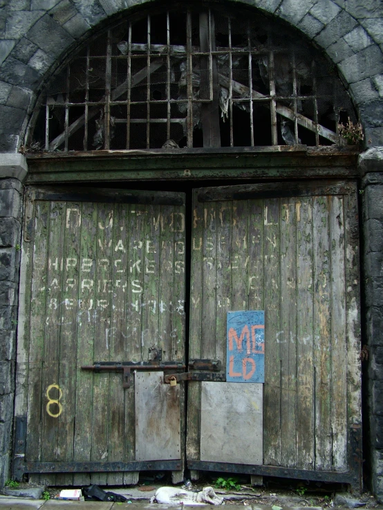 an old set of doors with a sign written out