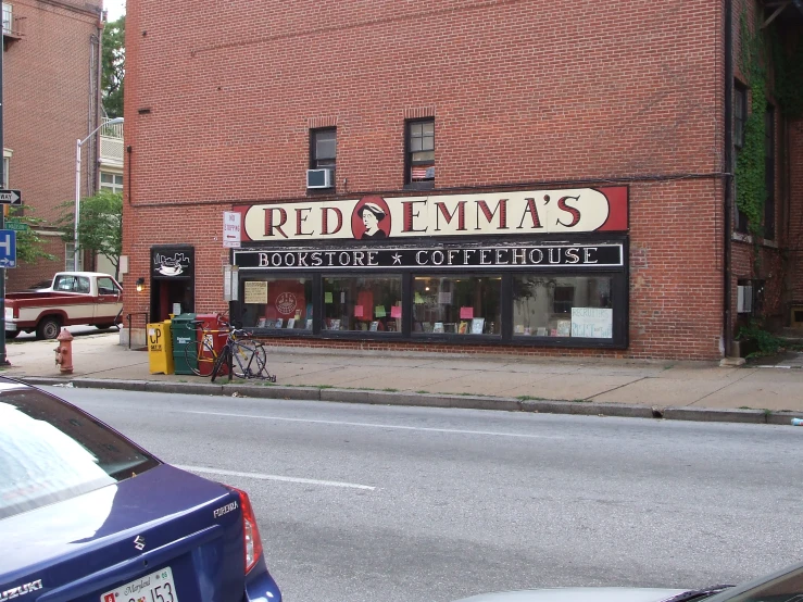 a red bricks building with a sign advertising clothing stores