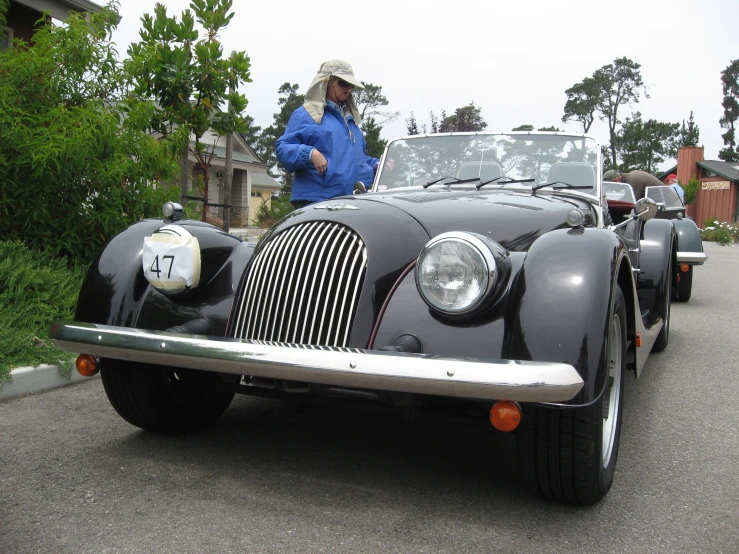 an old model black car on the street