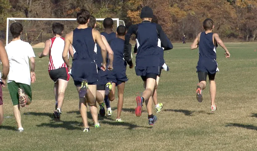 men running in the same direction in a soccer match