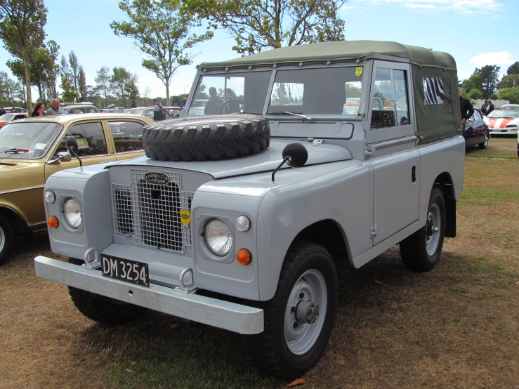 a grey land rover with a spare tire