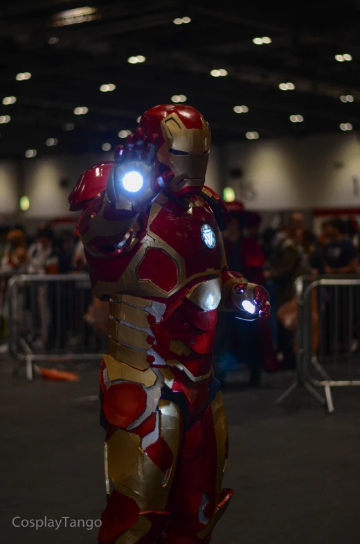 a man in iron man armor is illuminated by a flashlight