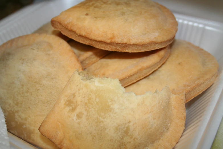 some small cookies with little white frosting on top of each