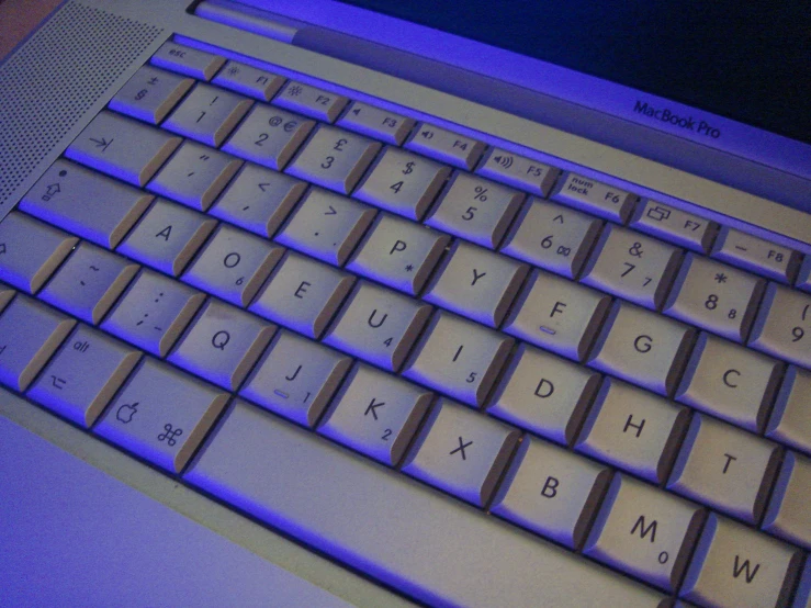 the keys on this white computer are blue