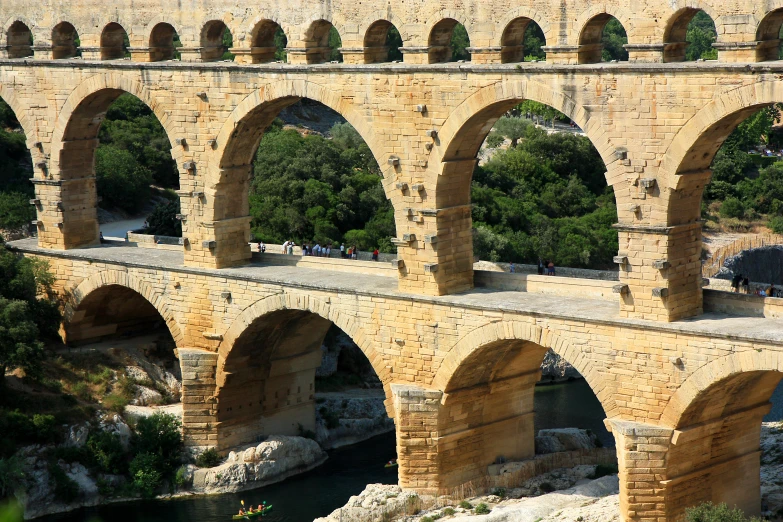 an old roman bridge is crossing the stream