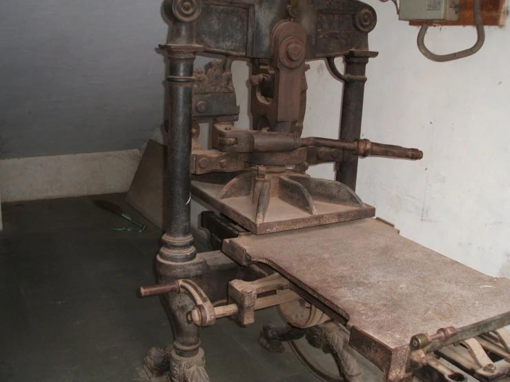 an old, very rusty machine and some wooden wheels