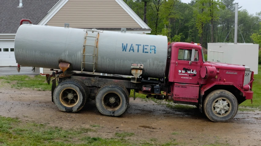 this is a large red truck that is in the mud