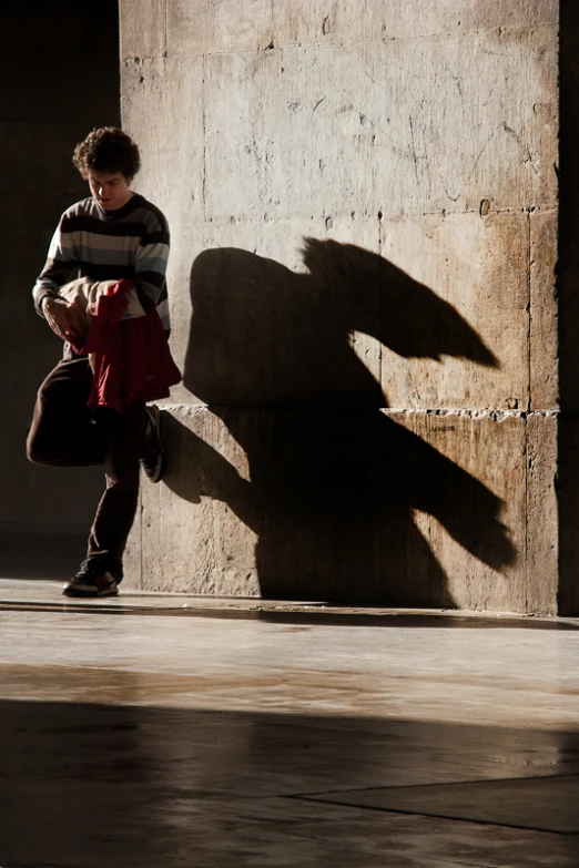 a person is standing by a concrete structure