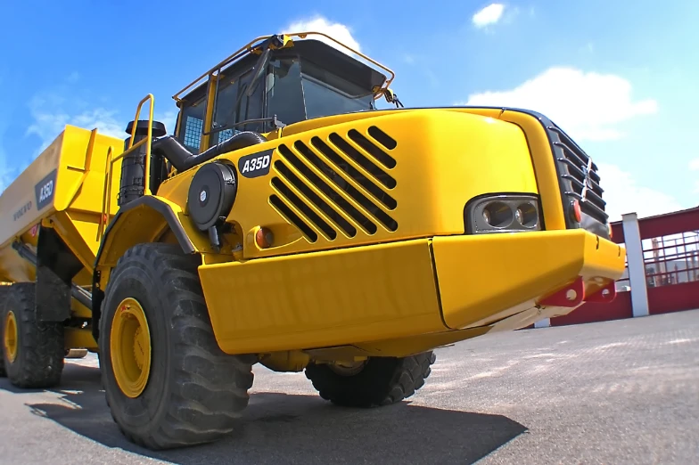 a large truck sits outside with its hood lifted