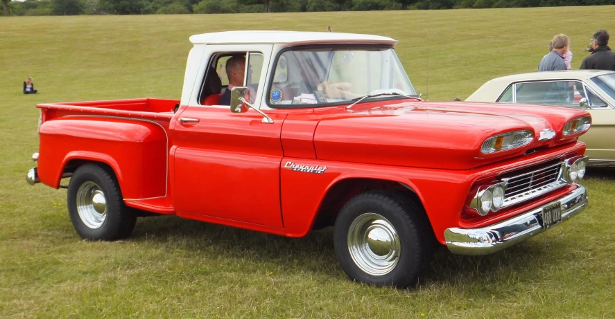 an older pickup truck on display at a car show