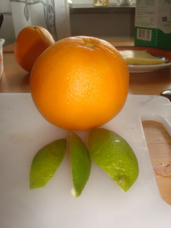 there are three limes on a chopping board