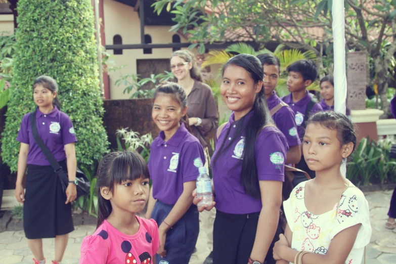 several children are posing for a po outside