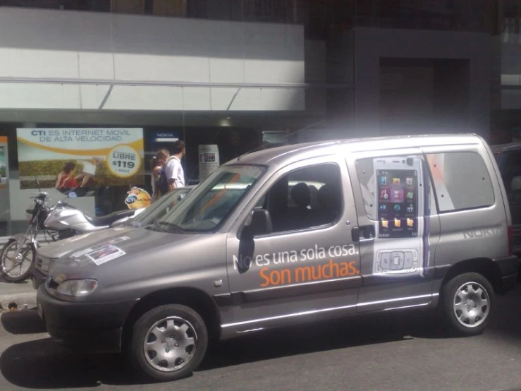 a van advertising sonnudas parked next to a parked bike