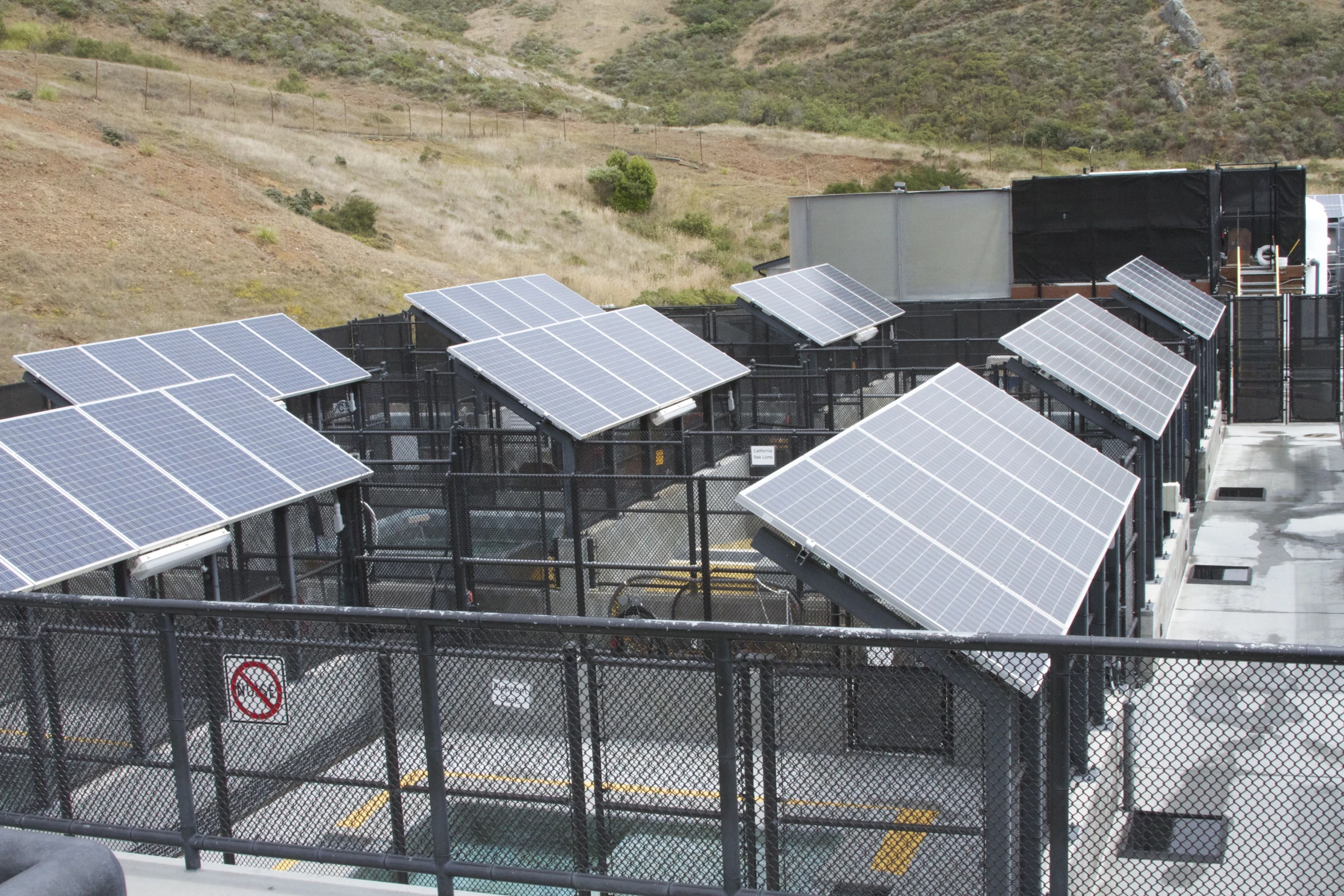 several buildings with metal railings and large solar panels