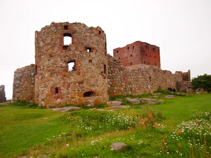 the two ruins of an old castle with holes in it