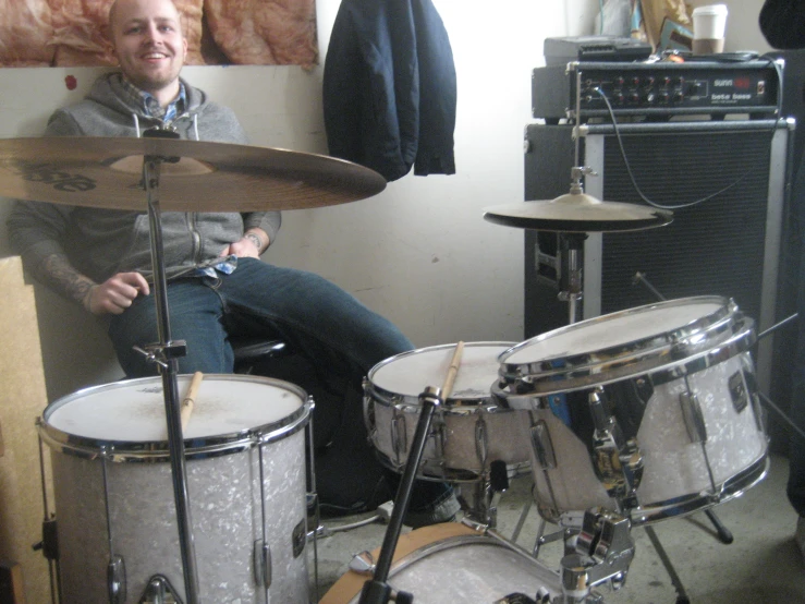 the man is sitting in front of his drums