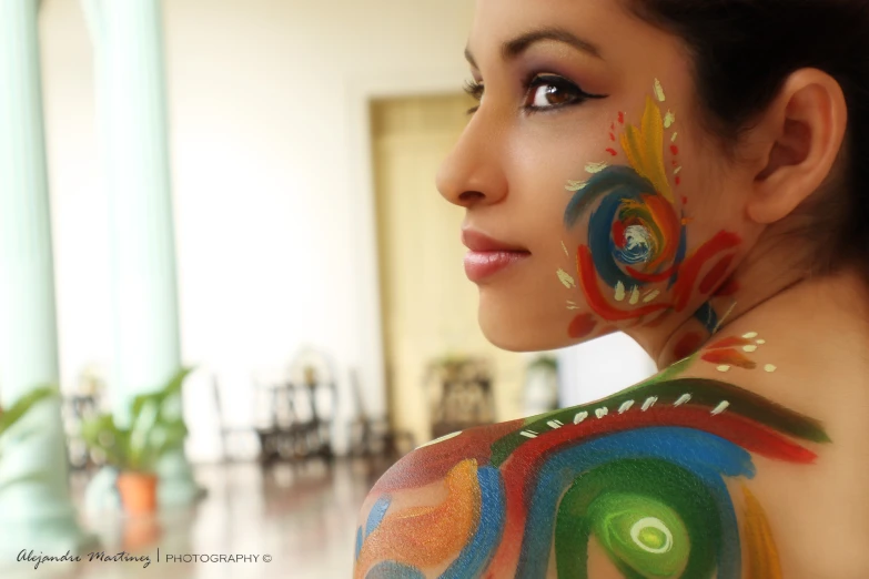 there is a woman with colorful body art on her