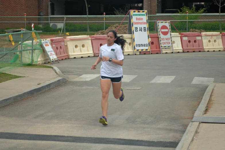 a woman running on a cement road