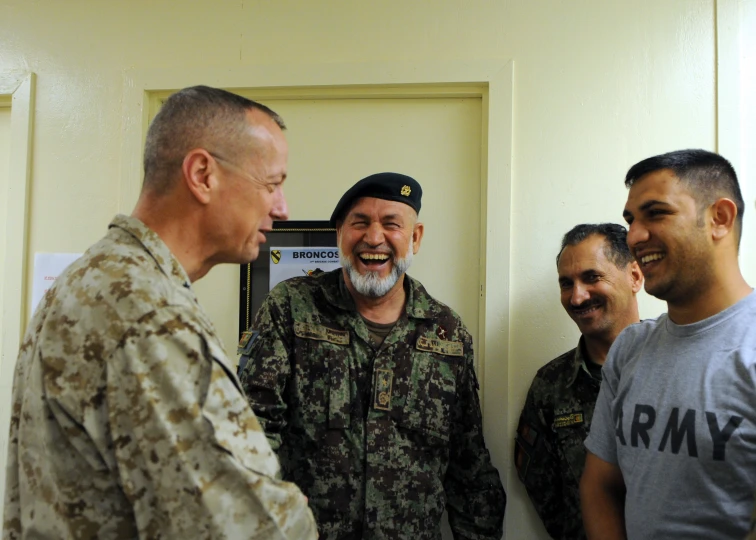 the men are talking to each other in military uniforms