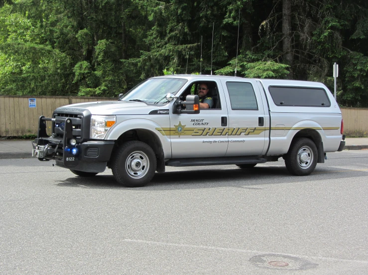 a white truck is traveling down the road