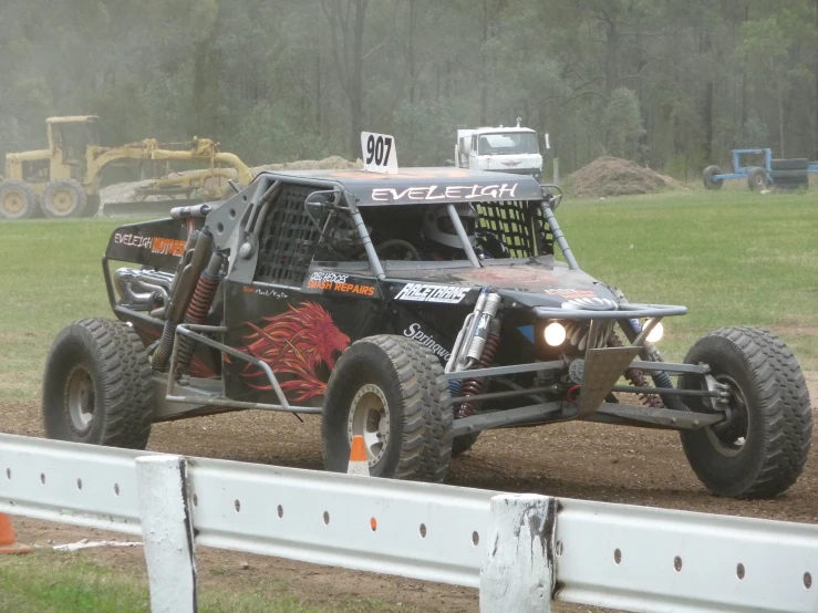 a buggy with big wheels is on a race track