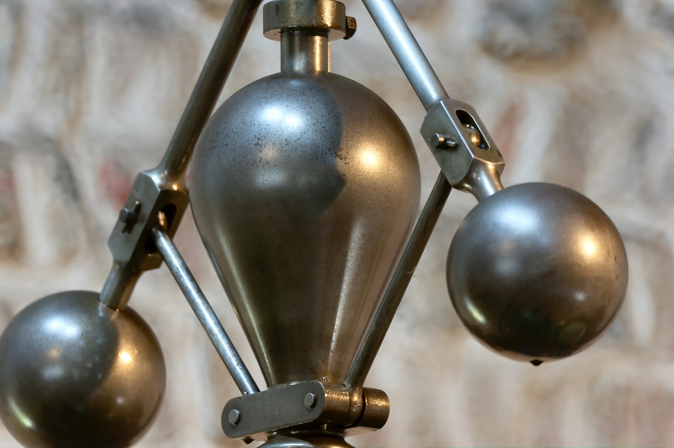 a decorative metal sculpture with three large spheres