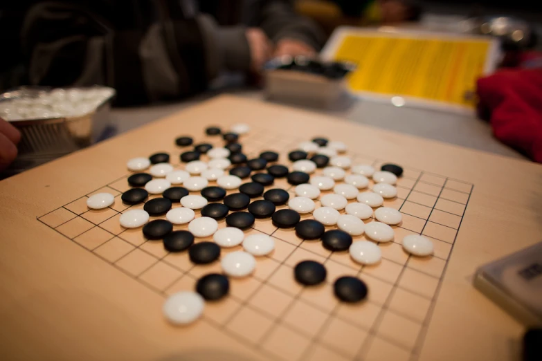 a board game with black and white plastic pieces