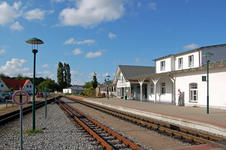 the train station is located next to the train tracks