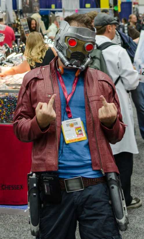 a man with a red jacket and a gas mask standing in the middle of a street