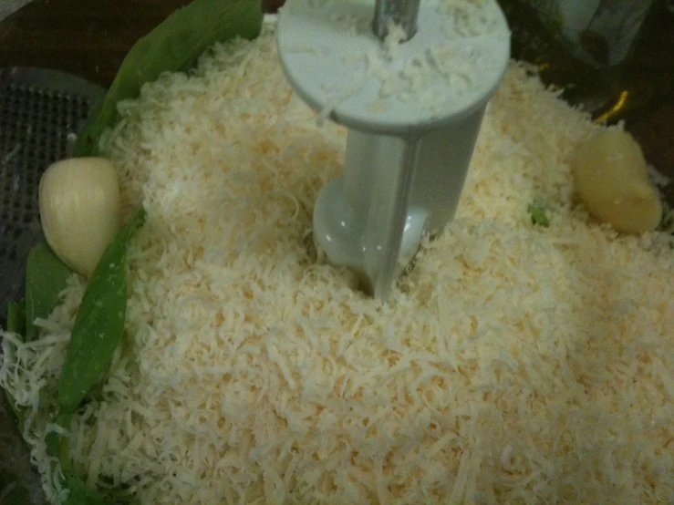 shredded cheese being processed in a food processor