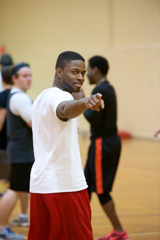 a man playing basketball with other players