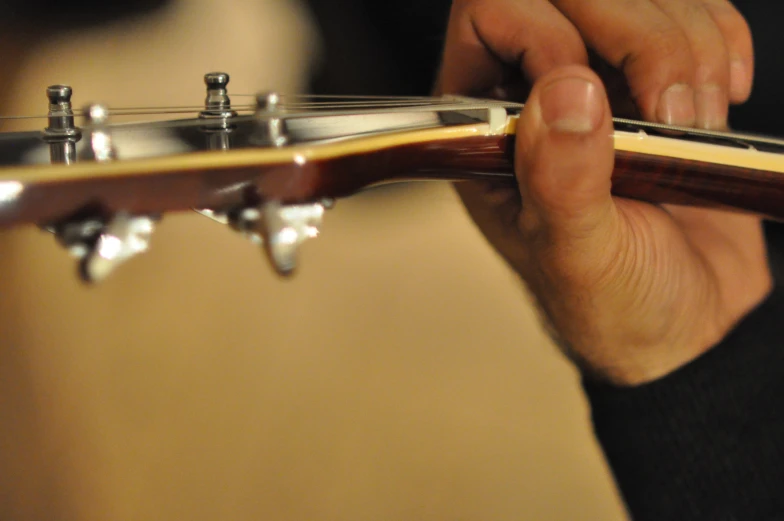 someone playing an electric guitar with their fingers