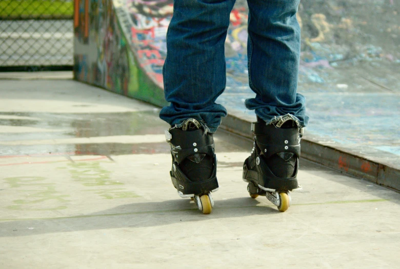 a close up of the legs and feet of a skateboarder