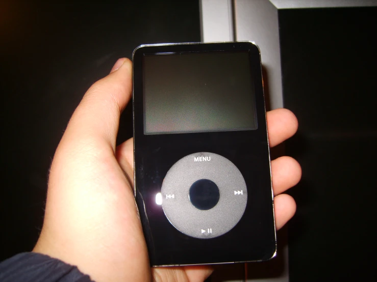 the new ipod is in the palm of someone